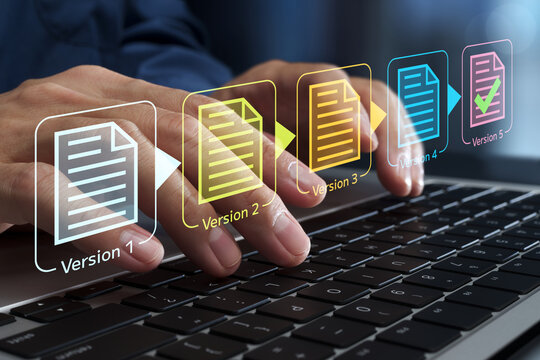 Document version control. Revision history and change tracking. Businessperson using laptop computer to edit documents.