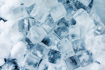 Ice cubes on the snow background.