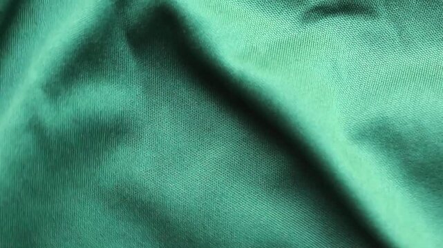Green sports clothing fabric football shirt jersey texture close up