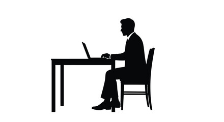 Fototapeta premium Silhouette of a businessman working on a laptop at a desk