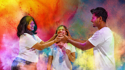 Three friends playfully smearing colors on each other at Holi festival. Concept of cultural moment,...