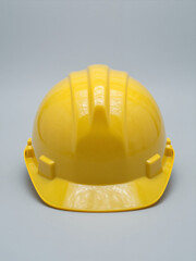 Fototapeta premium Yellow Hard Hat Isolated On Gray Background, Safety Construction Helmet, Front View