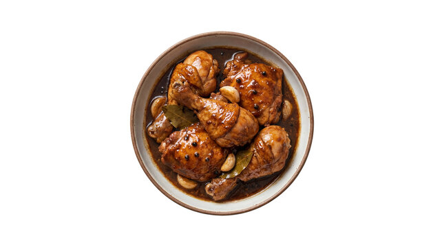 Filipino chicken adobo dish with garlic and bay leaves in a bowl, top view