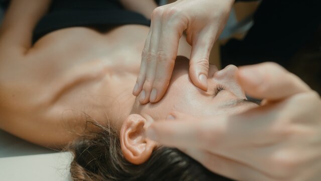 Professional treatment focusing on relaxing facial and neck fascia