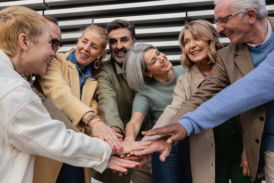 A diverse group of older people showing unity and teamwork outdoors