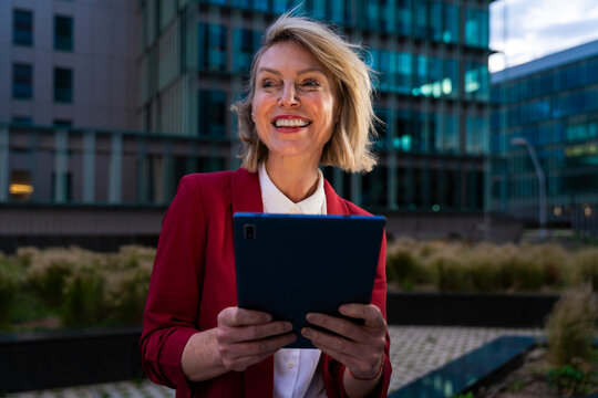 Businesswoman using tablet in urban setting during evening