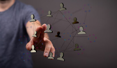 Abstract image showing a hand interacting with a network of connections and people symbols, symbolizing networking and s