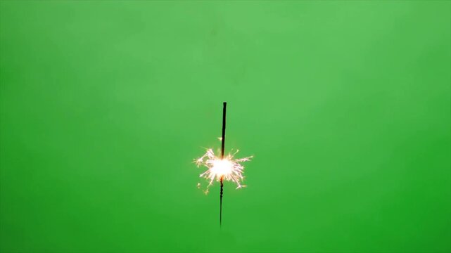 Burning sparkler firework on green screen background bright sparkling light festive celebration effect slow motion chroma key overlay 4k video footage