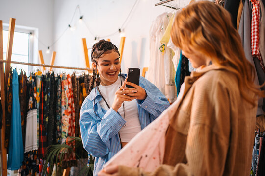 Enthusiastic Photographer Capturing Trendy Blossoms Amidst Vibrant Environment With Dazzling Illumination