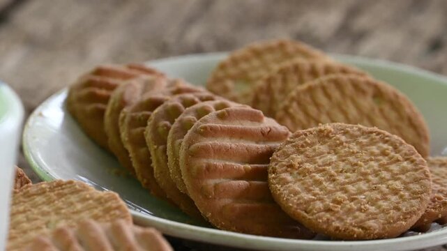 Biscuits and fresh milk on wooden background. a cup of milk and biscuits on a wooden table for a light breakfast.