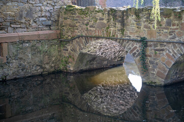 Old arch bridge with reflections in the water