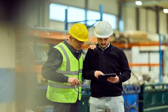 Factory Workers Inspecting Production Using Tablet &mdash; Teamwork and Safety on the Shop Floor
