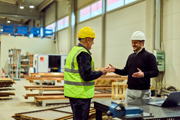 Factory Supervisor Handshake With Worker During Safety Inspection and Team Meeting in Warehouse