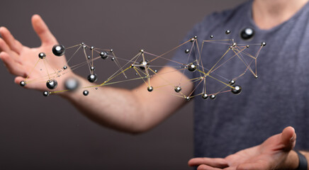 A person's hand interacting with a 3D network, representing digital connection, technology,...