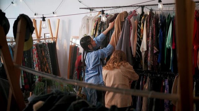 Collaborative Effort To Access And Prepare Delicate Fabrics For Photoshoot Under Gentle Lighting