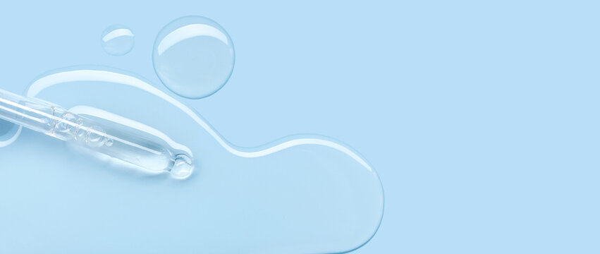 pipette drop of serum test on a blue background