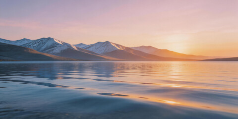 Obraz premium Serene Sunset Over Snow-Capped Mountains and Calm Lake