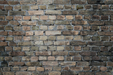 Obraz premium Old brick wall of a building, the photo shows the texture of yellow-brown bricks of the building's facade