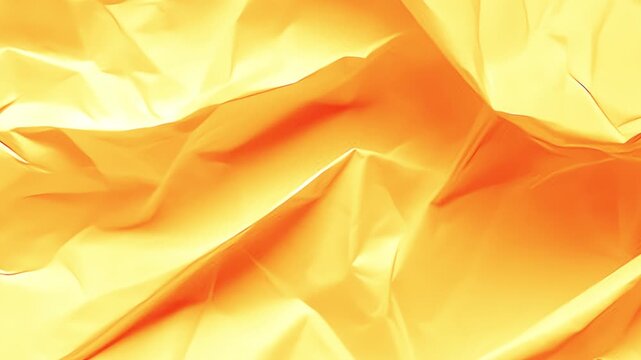 An abstract background of crumpled paper in orange tones with smooth folds and shadows.