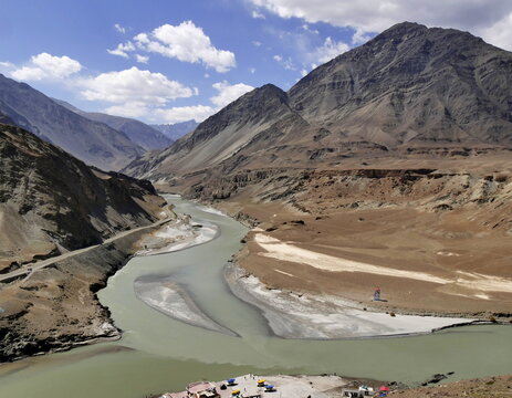 confluence of the Zanskar and Indus river in Ladakh, scenic landscape with two rivers merging into one in the mountains background