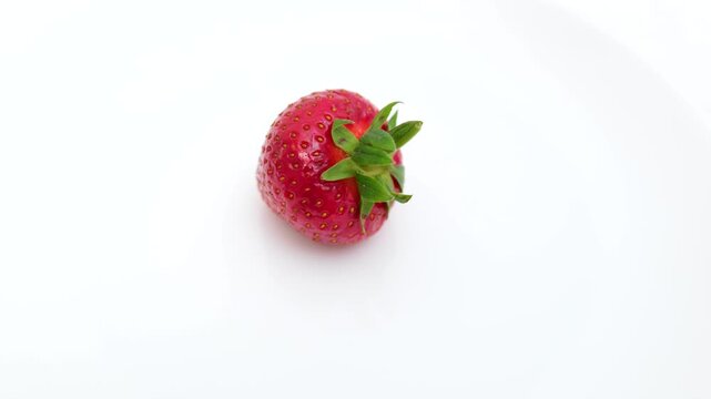 whole strawberry rotating on a white background.