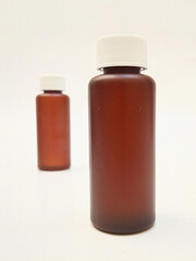 Amber plastic bottles with cap isolated on white background, brown plastic bottles for pharmaceuticals, syrups, essential oils, and cosmetics