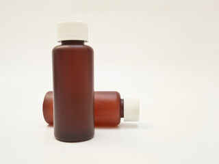 Amber plastic bottles with cap isolated on white background, brown plastic bottles for pharmaceuticals, syrups, essential oils, and cosmetics
