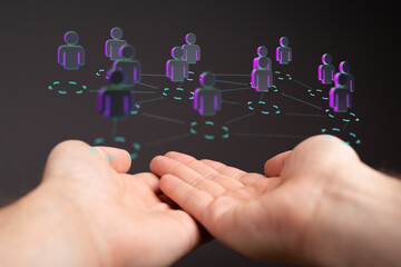 Hands cupping a futuristic network of people, representing connection, communication, and digital...