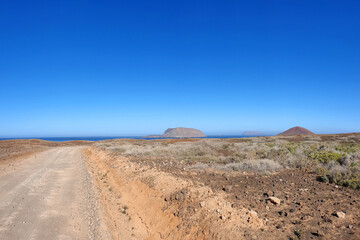Dirt road with Montana Clara and Montana Bermeja, Island La Graciosa, Canary Islands, Spain, Europe.