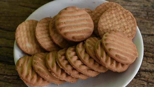 Biscuits and fresh milk on wooden background. a cup of milk and biscuits on a wooden table for a light breakfast.