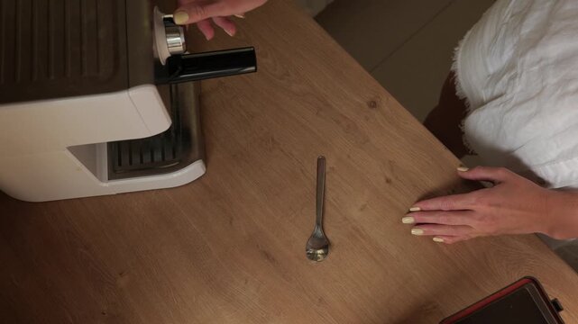 Preparing coffee with an espresso machine in a kitchen setting