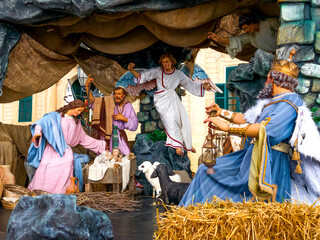Naklejka premium Nativity scene with Mary, Joseph, baby Jesus, angel and wise king in detailed Christmas tableau