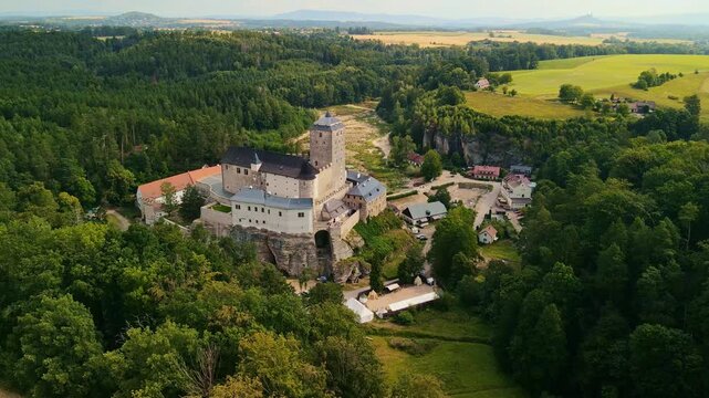 Sky Fortress Panorama. Majestic Aerial Castle Surveys Verdant Fields And Charming Village Life From Above