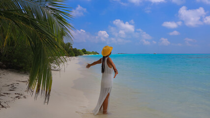 Happy holiday vacatuion with woman in white dress on the beach at the summer time