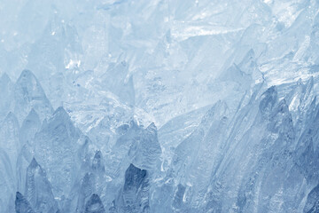 Obraz premium Natural ice formations as needles as crystalline pattern in cold seasonal environment. Concept of elemental beauty, serene wilderness mood. Macro detailed winter background with frozen icy icicles.