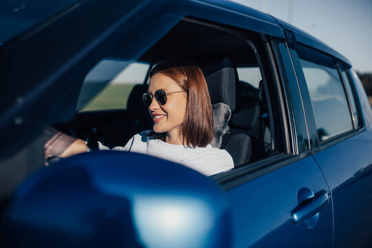 woman driving a car on a hot sunny day.