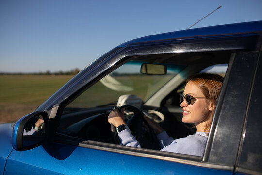 woman driving a car on a hot sunny day.