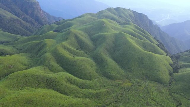 Aerial forward movement over mountain grassland in Wugong Mountain