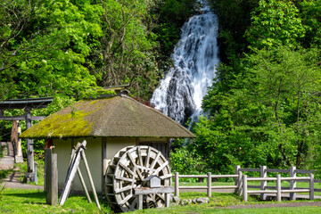 Fototapeta premium Traditional Watermill and Waterfall in Rural Village, Akita, Japan