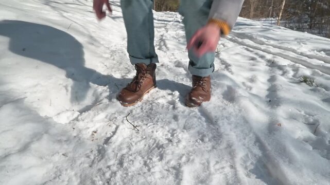 Close-up of a person finding lost keys in the snow in a forest on a winter day