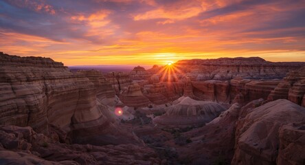 Sunset sky glowing above expansive desert rock formations