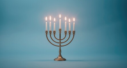 Fototapeta premium Menorah with bright candles on a serene blue backdrop featuring ample copy space for celebration