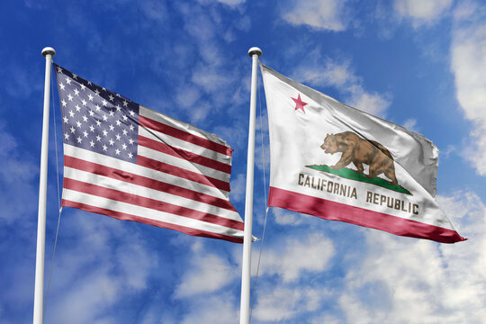 United States and California State Flags Waving Proudly Against a Blue Sky Symbolizing Federal Unity Golden State Heritage and the Historic Pioneer Spirit of the California Republic