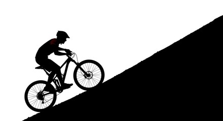 Obraz premium Silhouette of a mountain biker ascending a hill