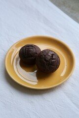 Chocolate Muffins on an Orange Plate &ndash; Homemade Sweet Dessert Concept
