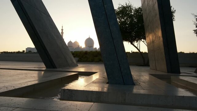 peaceful view from Wahat Al Karama Park at sunset, with golden light casting warm glow over serene landscape. iconic Sheikh Zayed Mosque stands beautifully in background, creating breathtaking scene.