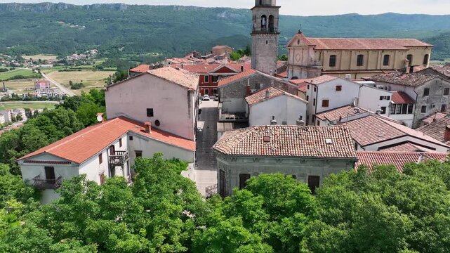 erial drone view of Buzet historic medieval town in Istria Croatia at early summer showing old stone buildings, hilltop settlement, surrounding forests and green valley landscape