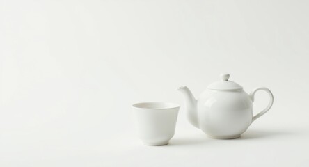 Fototapeta premium Teapot and teacup arranged elegantly on a solid white background