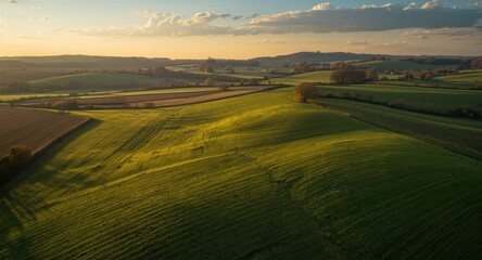 Rural farmland aerial with springtime green fields and patterns