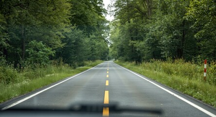 Obraz premium Roadway flanked by lush scenery designed for caravanning trips